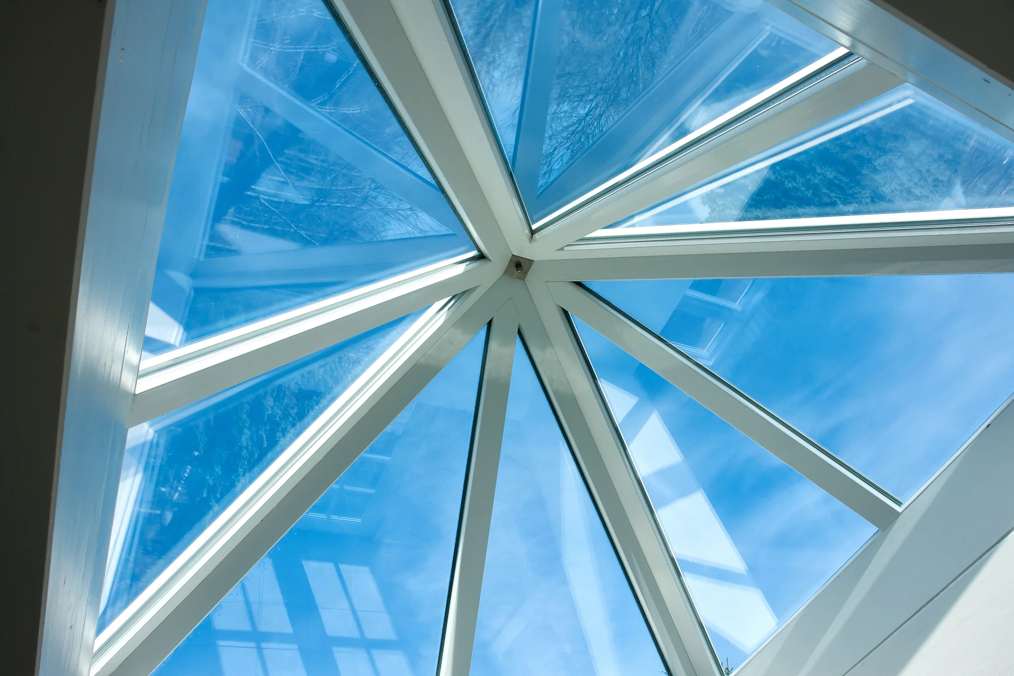 Glass conservatory roof lantern against a blue sky